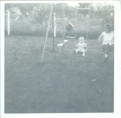 Alice baby on swing with Joann in Nanny's backyard